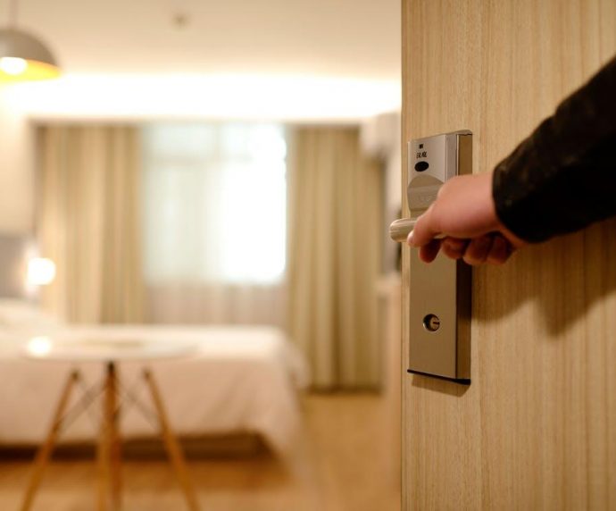 Concierge opening a hotel room door